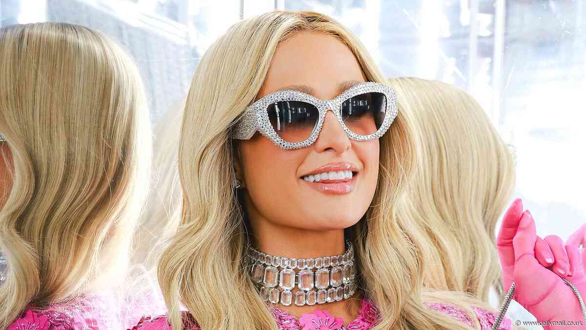 Paris Hilton stuns in a pink floral mini dress as she's supported by sister Nicky and pal Martha Stewart at her Parívie launch party in NYC