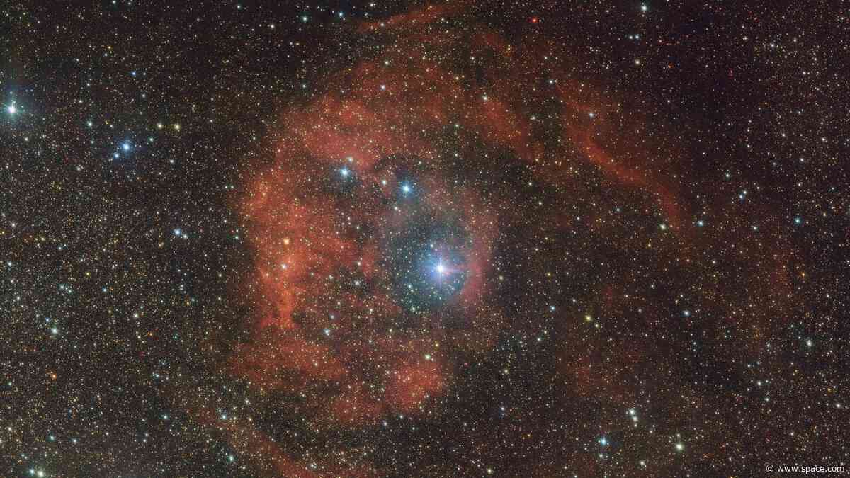 Cosmic imposter bathes distant nebula in fiery red glow: 'This star should not be here'