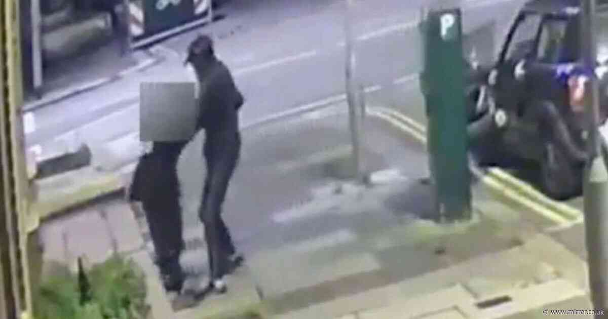 Harrowing moment balaclava-clad thug randomly snatches woman off street