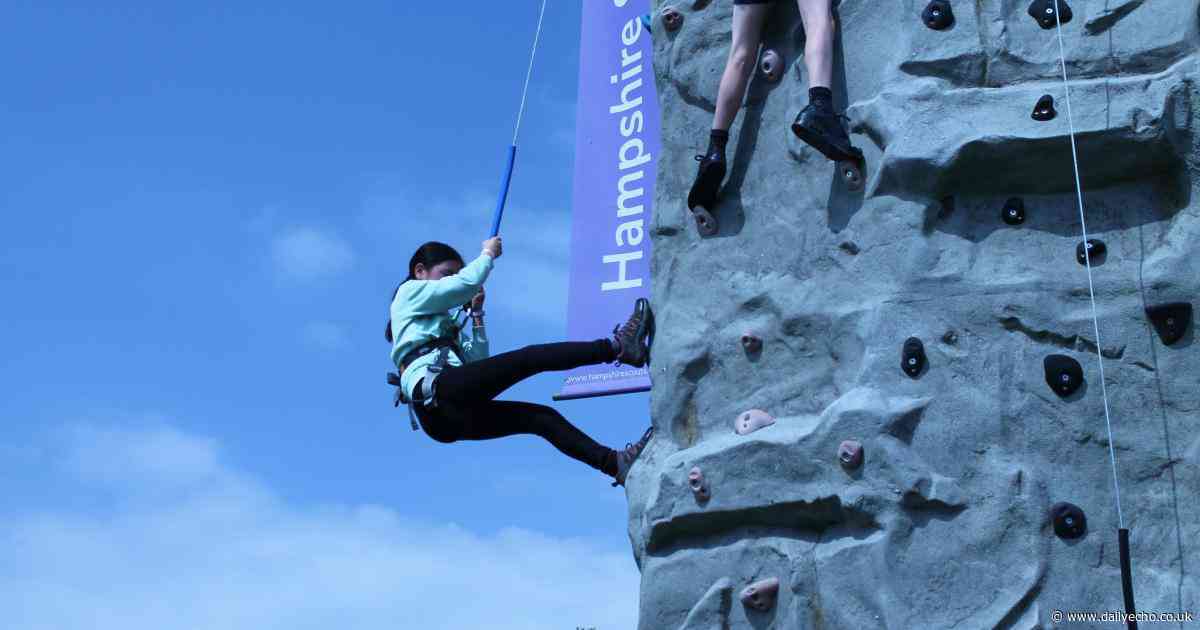 Hundreds of scouts go wild at camp with climbing wall and petting zoo