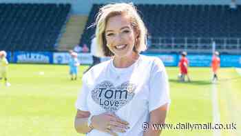 Pregnant Kelsey Parker cradles her baby bump as she leads stars at annual charity football match in memory of her late husband Tom
