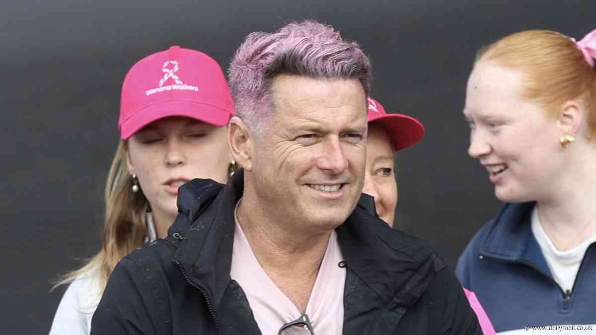 Today show host Karl Stefanovic shows off his new pink hair as he participates in the Mother's Day Classic walk with his wife Jasmine