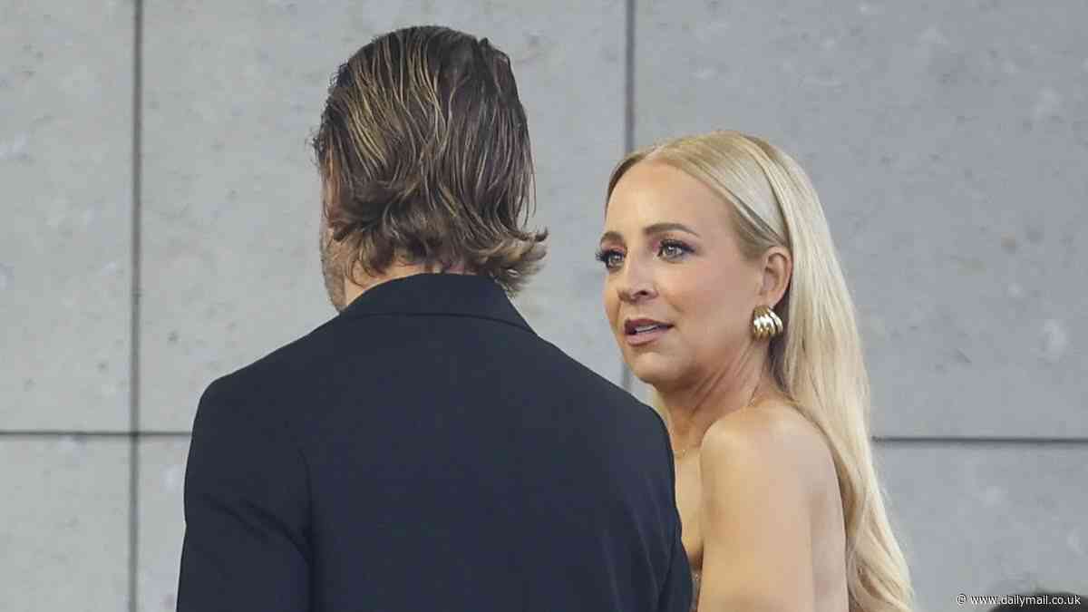 Awkward! Carrie Bickmore's seating faux pas at Australian Fashion Week as she is asked to move at the AJE show by burly front row controller