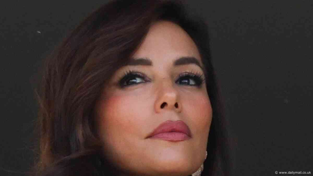 Eva Longoria cuts a glamorous figure as she poses on her hotel's balcony before heading to the opening ceremony of the Cannes Film Festival
