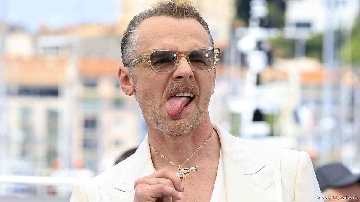 Simon Pegg shows off his edgy new look as he poses with a diamond gun necklace at Mission Impossible photocall during Cannes Film Festival