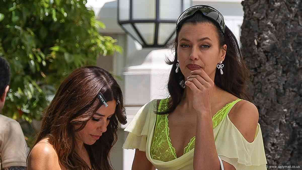 Irina Shayk risks wardrobe malfunction in a plunging yellow dress and lace bralette as she meets Eva Longoria for lunch in Cannes during film festival