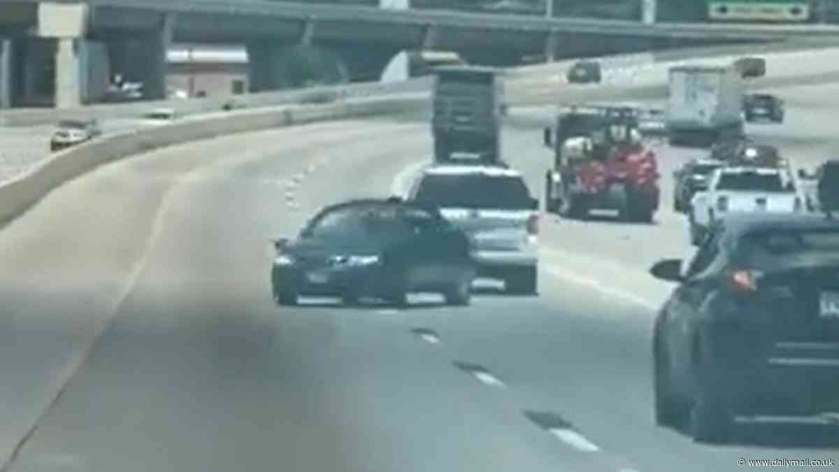 Terrifying video shows out-of-control Saab 'reversing' wrong way down busy Texas freeway with driver inside