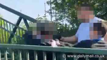 Horror moment man grabs schoolboy 'to stop him escaping while pack of students attack him': Two arrested