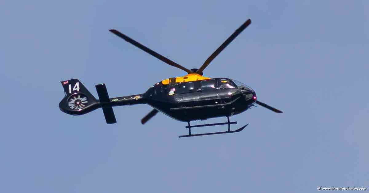 Striking military helicopter circles over city