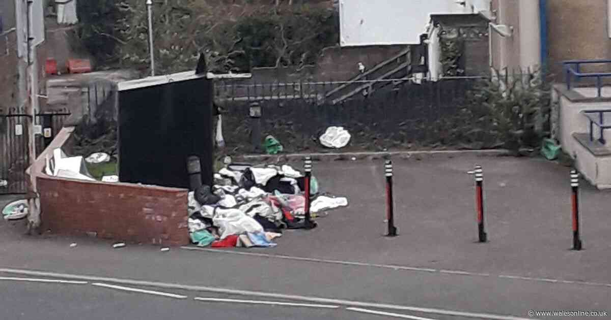 Piles of rubbish build up at 'nightmare' clothes bank as woman strips off in the street