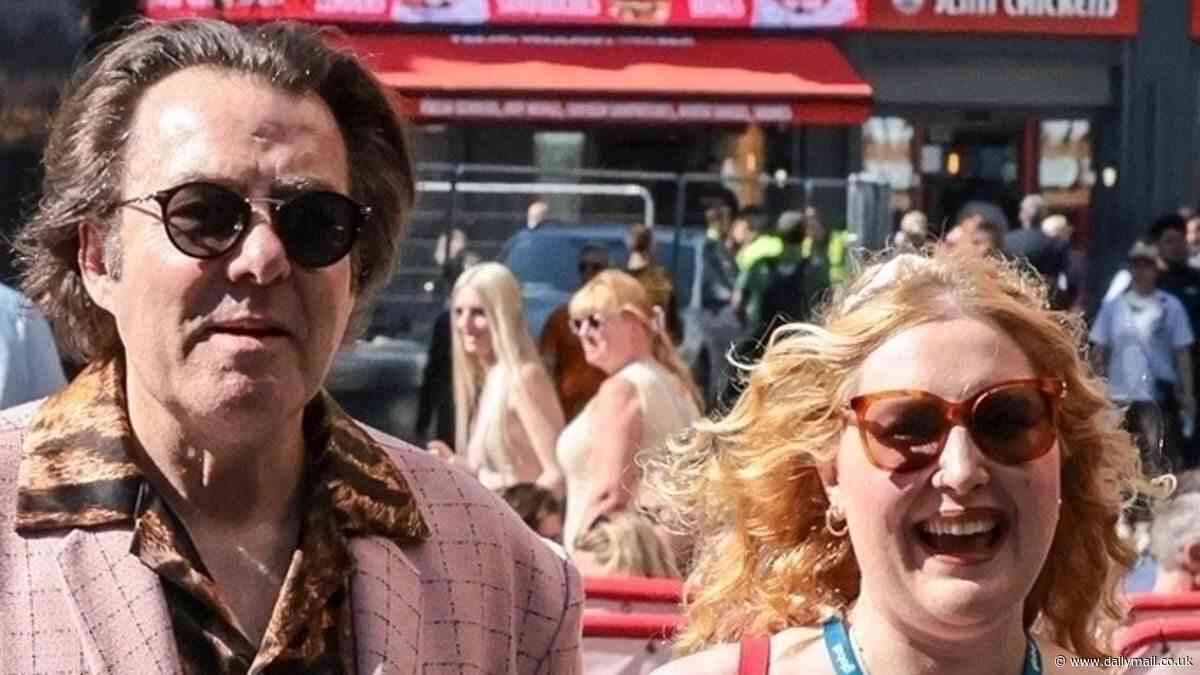 Jonathan Ross, 64, wears a quirky pink jacket and tiger print shirt as he and daughter Honey Kinny, 28, spend the day together