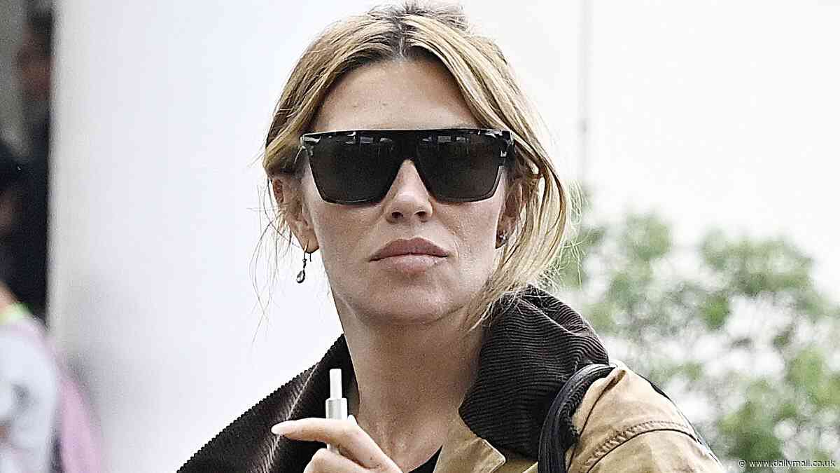 Abbey Clancy puffs away on an e-cigarette as she arrives in Palma De Mallorca ahead of a 24-hour holiday