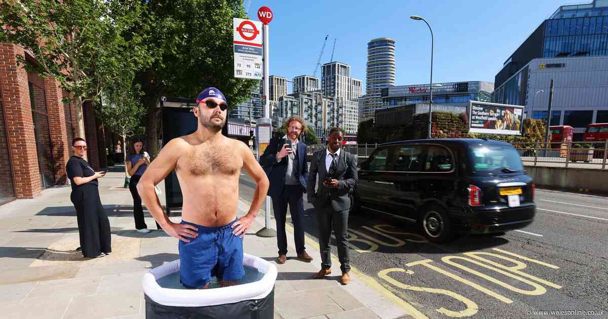 Bemused commuters spot man taking an ice bath outside a bus stop as balmy weather continues