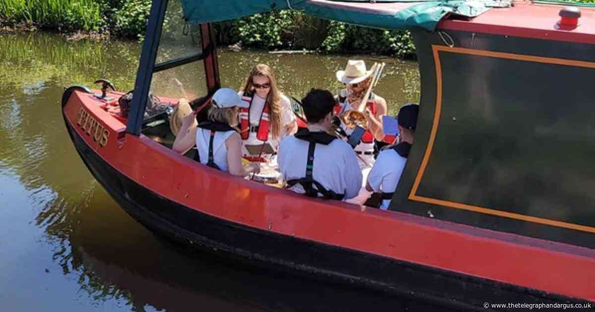 Flotilla of musicians charms crowds while meandering along canal in Bradford