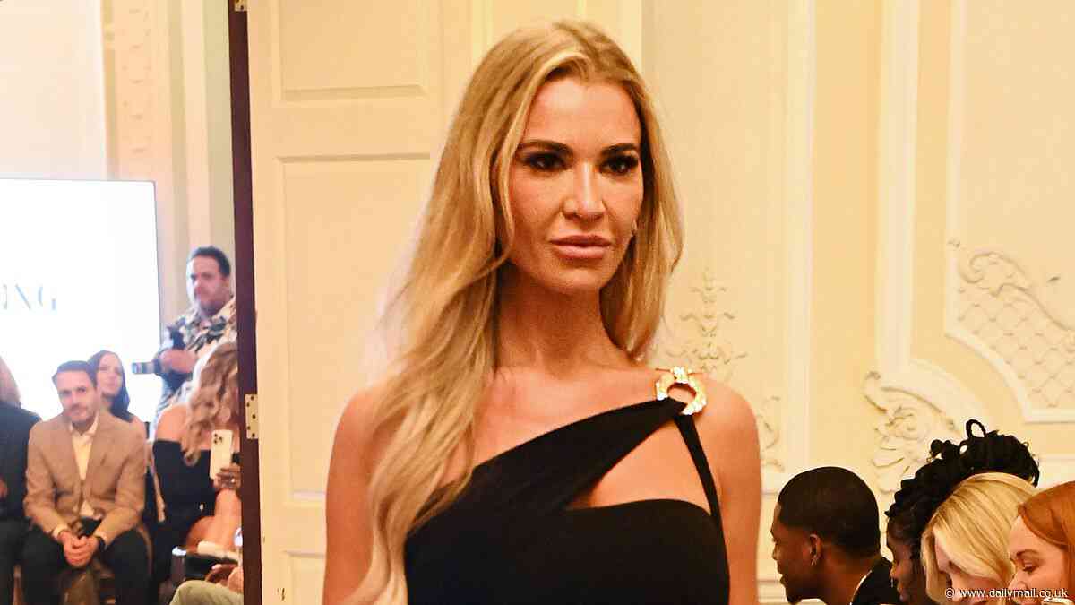 Christine McGuinness puts on a very leggy display in a black mini dress as she struts down the runway at the Models Of Diversity: Fashioning Change event