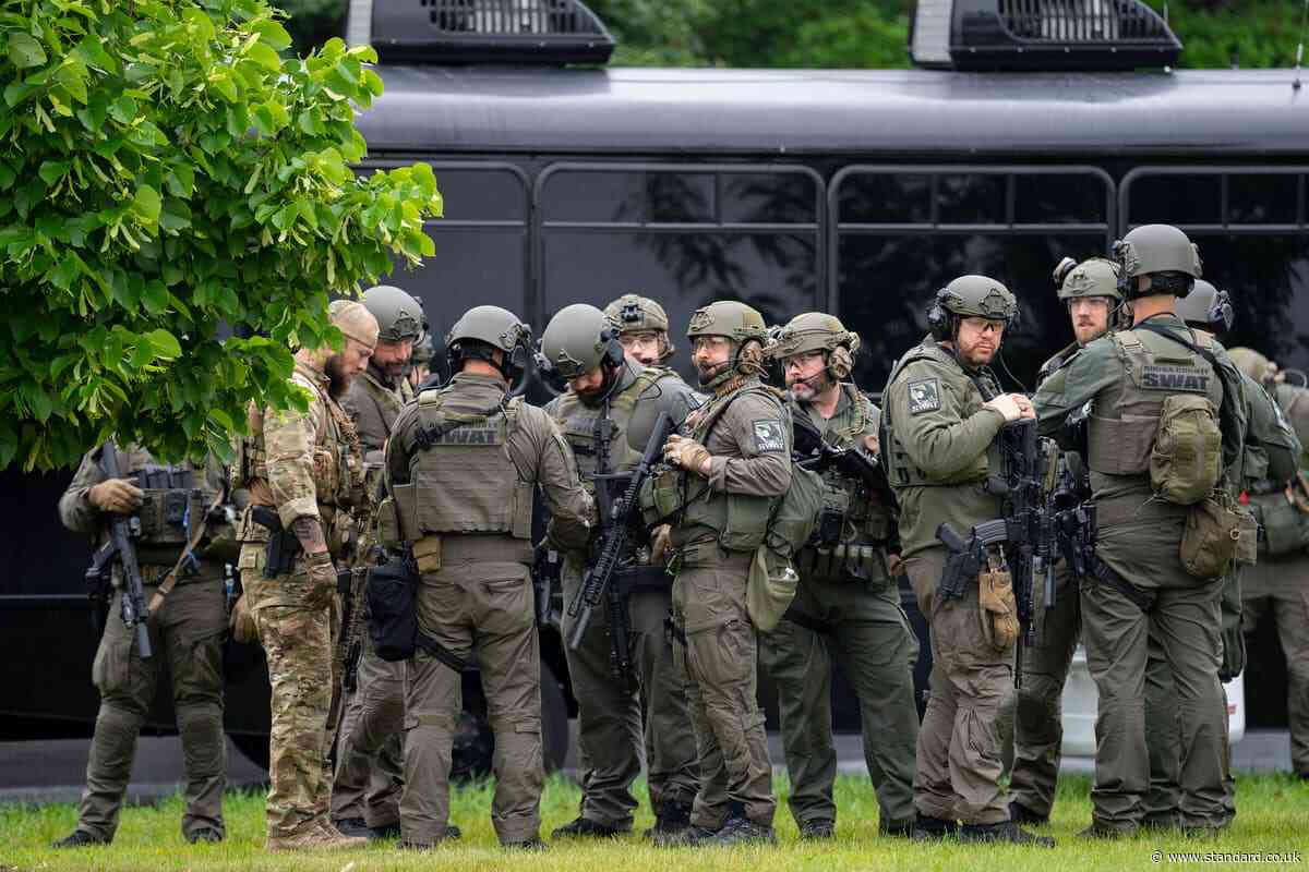 US politician and husband shot dead in 'politically motivated assassination' by suspect dressed as police officer