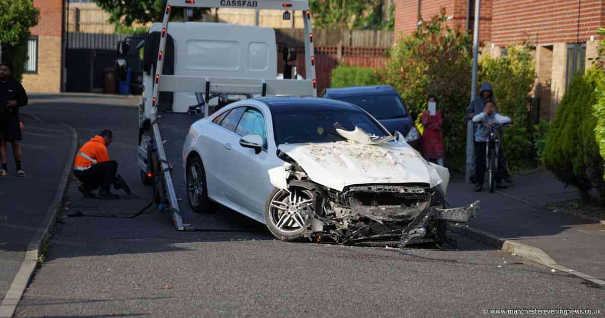 Person injured after car crashes into house as firefighters race to scene