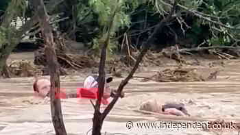 Residents cling to rope as Texas floodwater surges around them