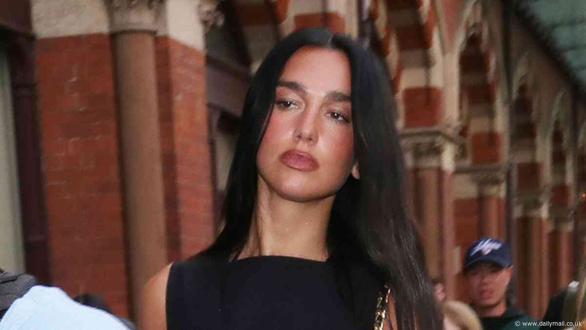 Dua Lipa puts on a leggy display in a black mini dress as she arrives back in London after glamorous Paris Fashion Week appearance and Mallorca trip