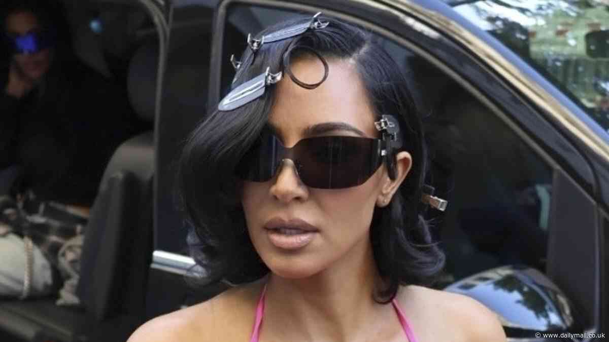 Kim Kardashian puts on a VERY busty display as she goes braless beneath a plunging pink dress while arriving for a Balenciaga fitting in Paris